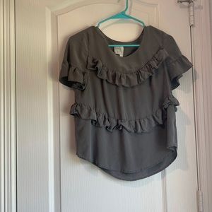 A size small and is grey with ruffles
